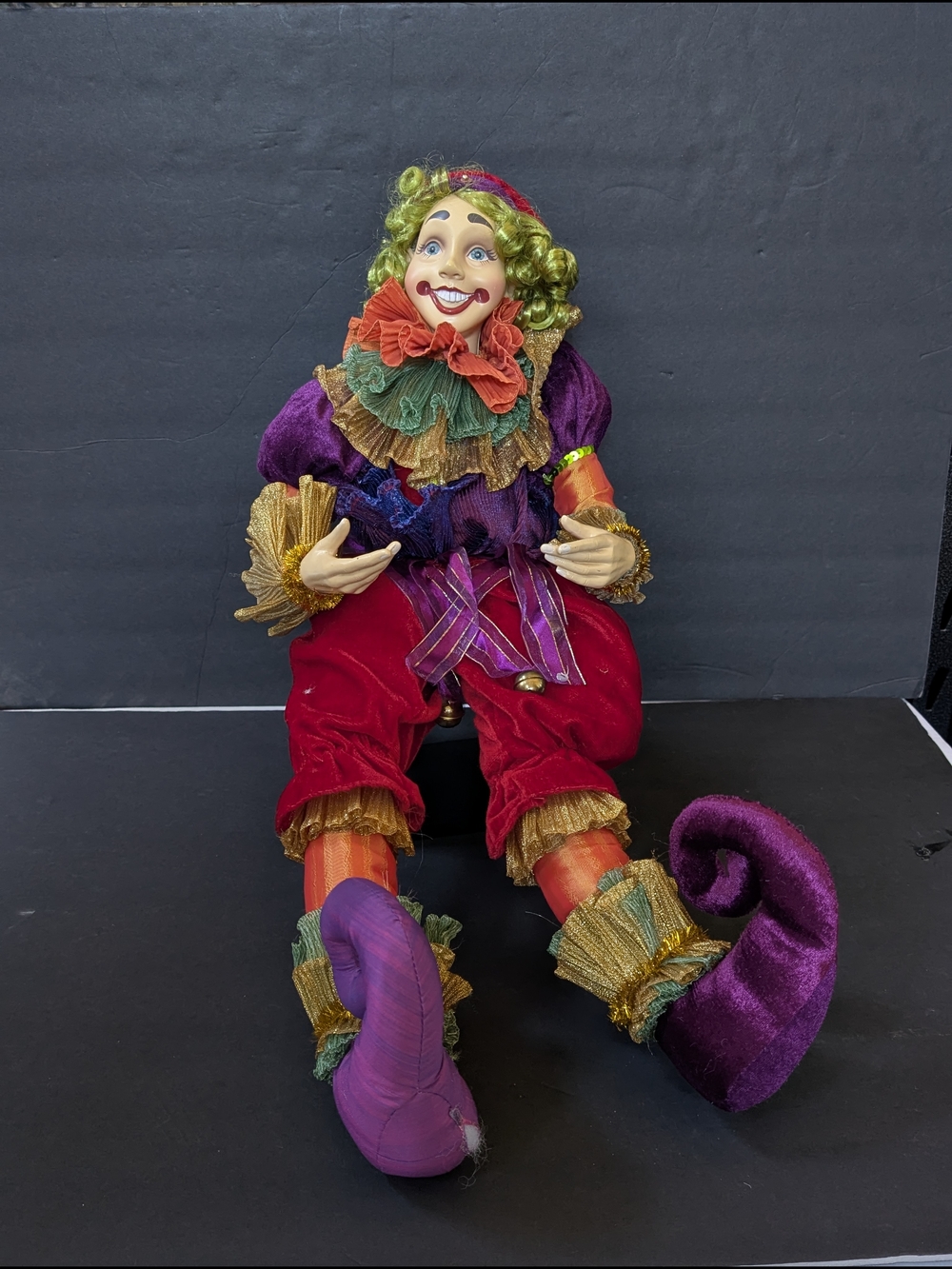Shelf sitting clown jester doll. Multicoloured clown doll